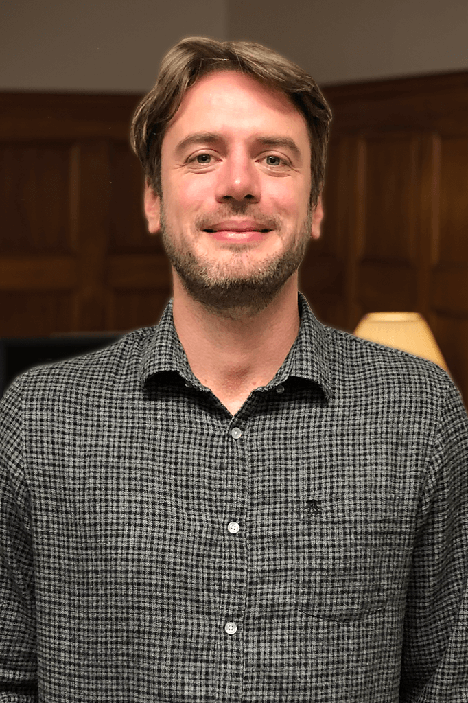 Portrait of Sean in an interior office decorated in a traditional collegiate-style