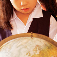 student examining globe